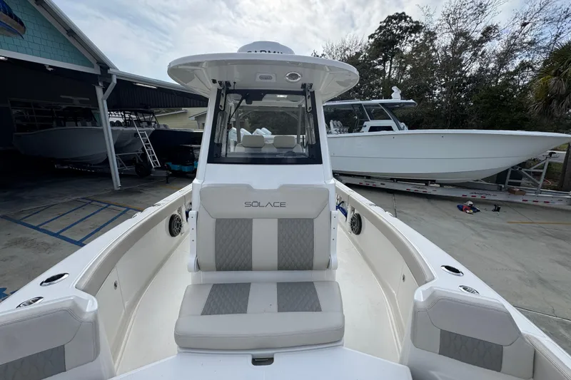 Slide: The Image of 2026 Solace 28 HCS boat in a marina, showcasing sleek design and modern features. - 21