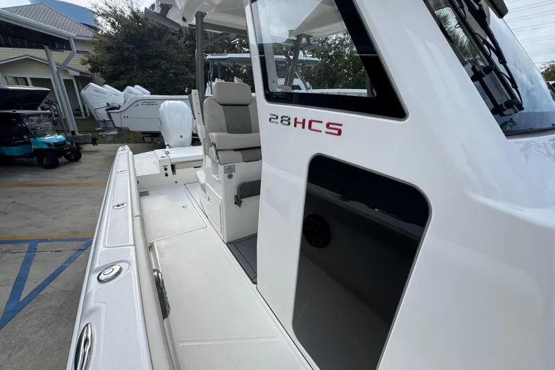 Slide: The Image of 2026 Solace 28 HCS boat, side view, showcasing sleek design and seating area. - 23