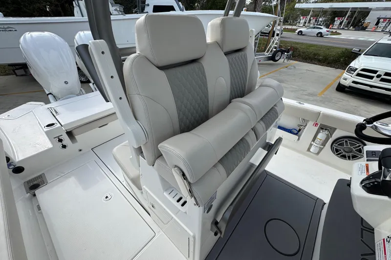 Slide: The Image of 2026 Solace 28 HCS boat interior with dual cushioned seats and modern controls. - 26