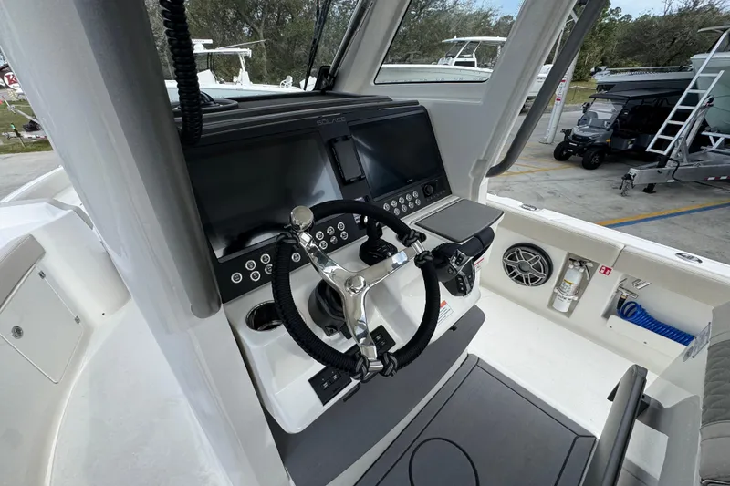 Slide: The Image of 2026 Solace 28 HCS boat cockpit with modern steering and control panel. - 27