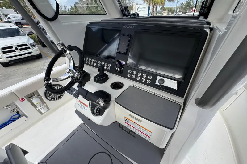Slide: The Image of 2026 Solace 28 HCS boat dashboard with steering wheel and control panel. - 29