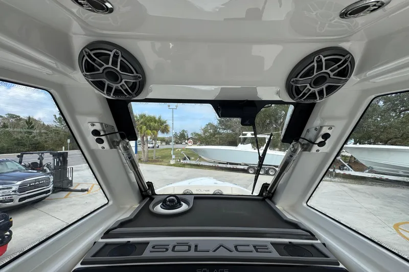 Slide: The Image of Interior view of 2026 Solace 28 HCS boat with speakers and windshield. - 31