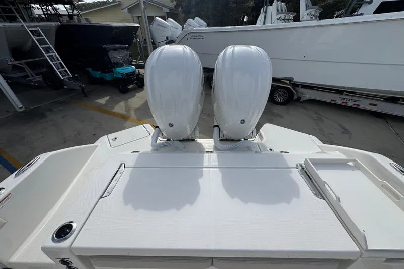 Slide: The Image of 2026 Solace 28 HCS boat with dual outboard engines in a marina setting. - 36