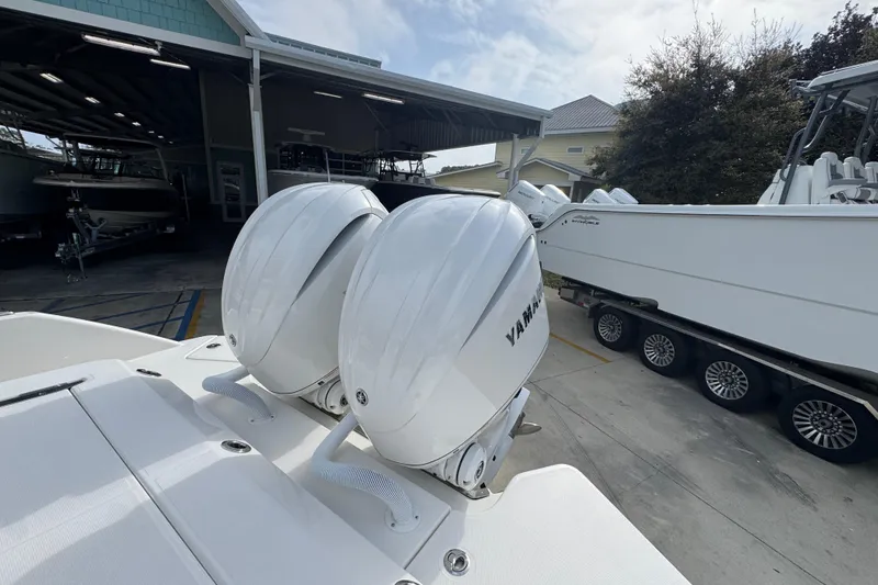 Slide: The Image of 2026 Solace 28 HCS boat with dual Yamaha outboard engines in a marina setting. - 37