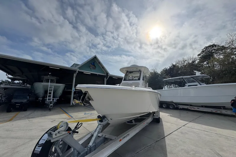 Slide: The Image of 2026 Solace 28 HCS boat on trailer under cloudy sky at marina. - 4
