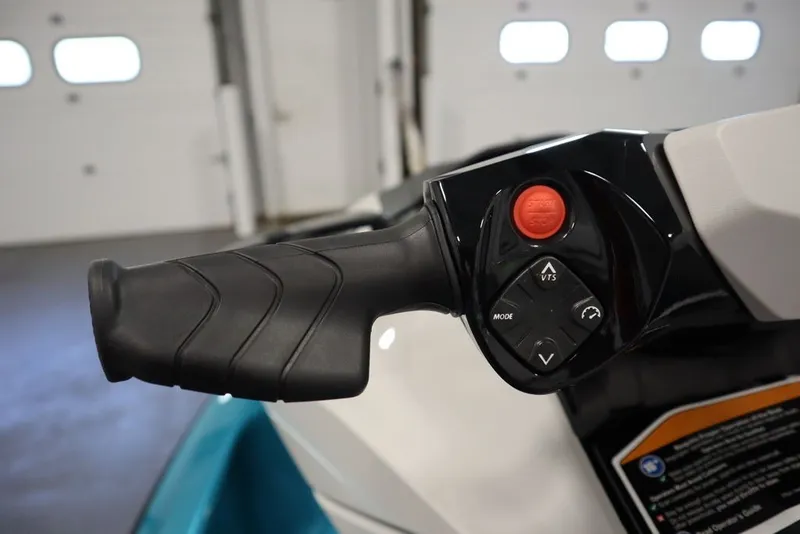 Slide: The Image of Close-up of 2026 Sea-Doo GTI SE 130 handlebar controls in a garage setting. - 17