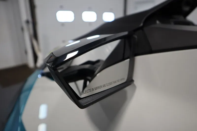 Slide: The Image of Side mirror of 2026 Sea-Doo GTI SE 130, reflecting interior garage view. - 15