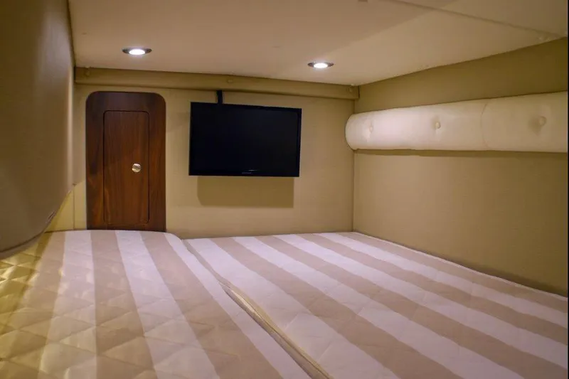 Slide: The Image of Manufacturer Provided Image: 2019 Rinker 320 EX cabin interior with TV and bed. - 18