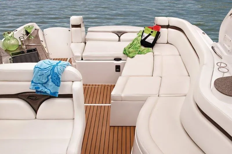 Slide: The Image of Manufacturer Provided Image: 2019 Rinker 320 EX boat interior with white seating and wooden flooring. - 8