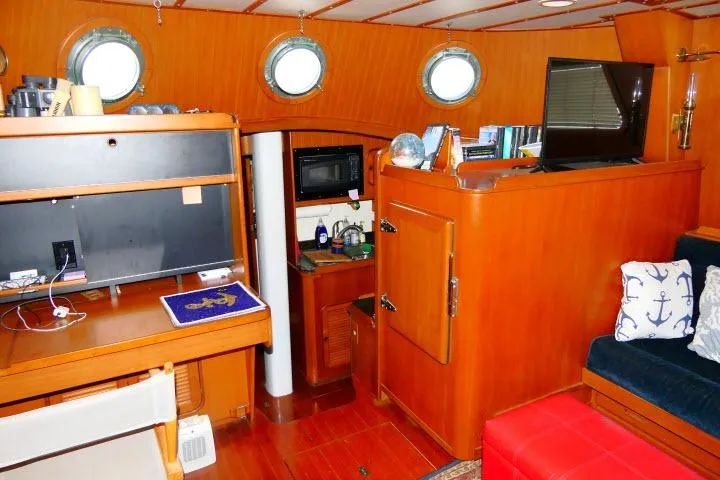 Slide: The Image of Interior of 1982 Ta Shing Mason 63 yacht with books, TV, and porthole window. - 10