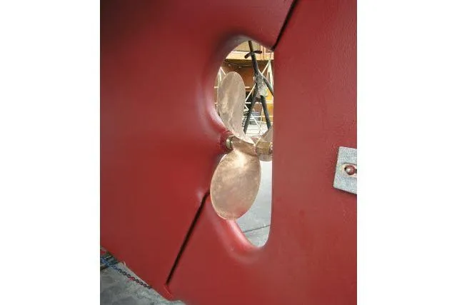 Slide: The Image of Red hull of 1982 Ta Shing Mason 63 yacht with visible propeller. - 102