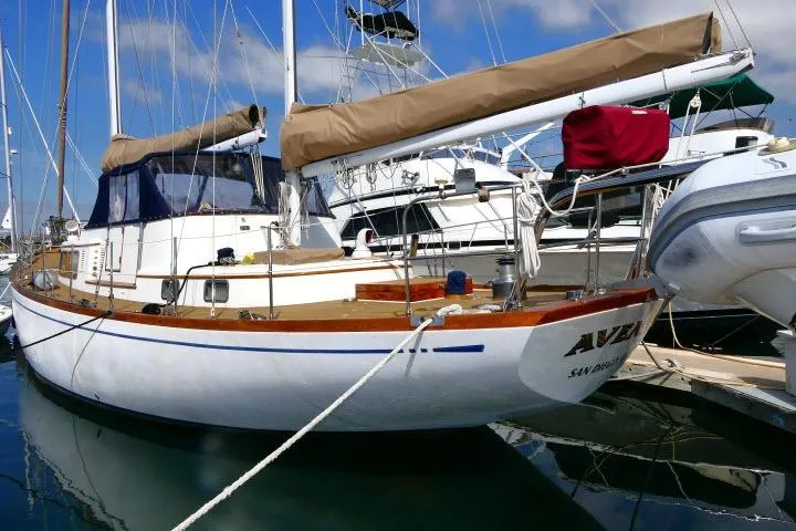 Slide: The Image of 1982 Ta Shing Mason 63 sailboat docked, featuring classic design and wooden accents. - 110