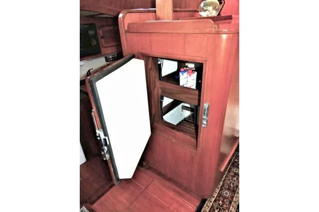Slide: The Image of Interior of 1982 Ta Shing Mason 63 yacht with wooden cabinetry and framed nautical map. - 13