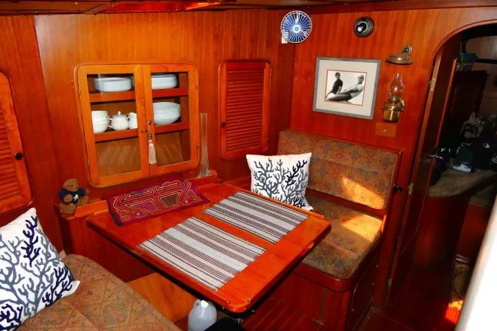 Slide: The Image of Cozy 1982 Ta Shing Mason 63 yacht interior with wooden dining area and nautical decor. - 15