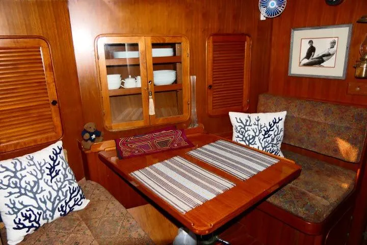 Slide: The Image of Cozy 1982 Ta Shing Mason 63 yacht interior with dining area and nautical decor. - 16
