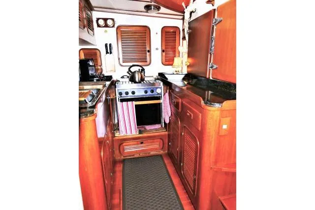 Slide: The Image of Compact kitchen in 1982 Ta Shing Mason 63 yacht with microwave, sink, and stove. - 20