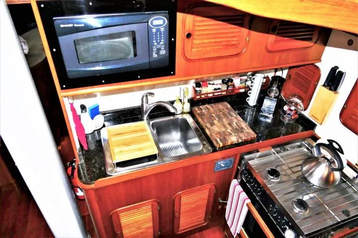Slide: The Image of 1982 Ta Shing Mason 63 yacht kitchen with wooden cabinets and modern appliances. - 21