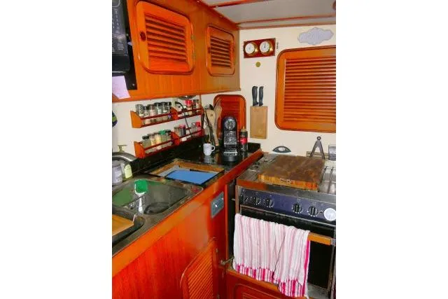 Slide: The Image of Microwave in 1982 Ta Shing Mason 63 yacht kitchen with wooden cabinets and countertop. - 22