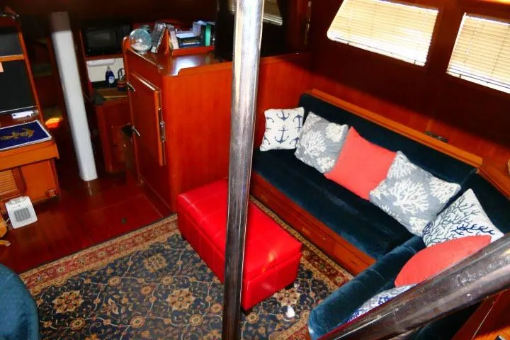 Slide: The Image of Cozy 1982 Ta Shing Mason 63 yacht interior with nautical-themed cushions and wooden paneling. - 3