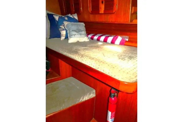 Slide: The Image of Cozy cabin interior of 1982 Ta Shing Mason 63 sailboat with cushions and wooden accents. - 31