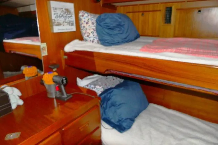 Slide: The Image of Interior of 1982 Ta Shing Mason 63 yacht with wooden bunk beds and blue pillows. - 35