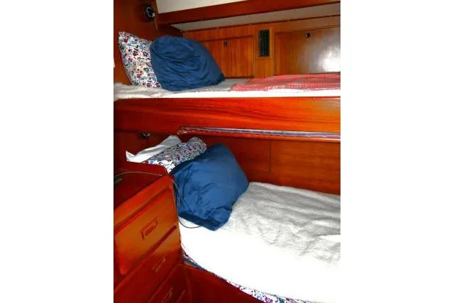 Slide: The Image of 1982 Ta Shing Mason 63 yacht interior with wooden drawers and cozy bedding. - 36
