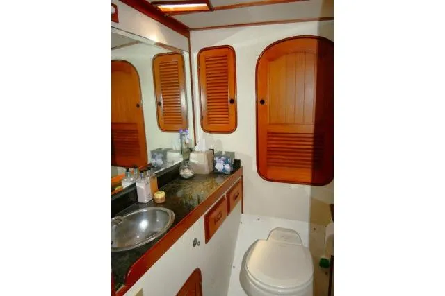 Slide: The Image of 1982 Ta Shing Mason 63 yacht bathroom with wooden cabinets and stainless steel sink. - 39