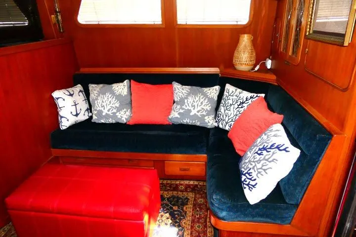 Slide: The Image of Cozy 1982 Ta Shing Mason 63 yacht interior with blue sofa and decorative pillows. - 4