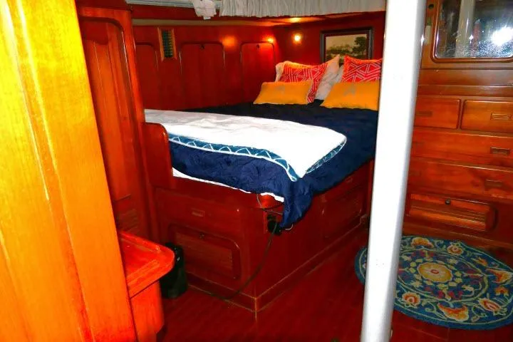 Slide: The Image of Luxurious wooden cabin interior of 1982 Ta Shing Mason 63 yacht with cozy bedding. - 42