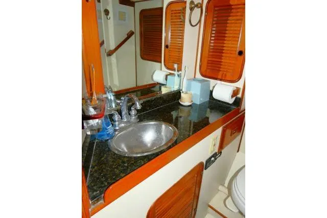 Slide: The Image of 1982 Ta Shing Mason 63 yacht bathroom with wooden accents and compact design. - 49