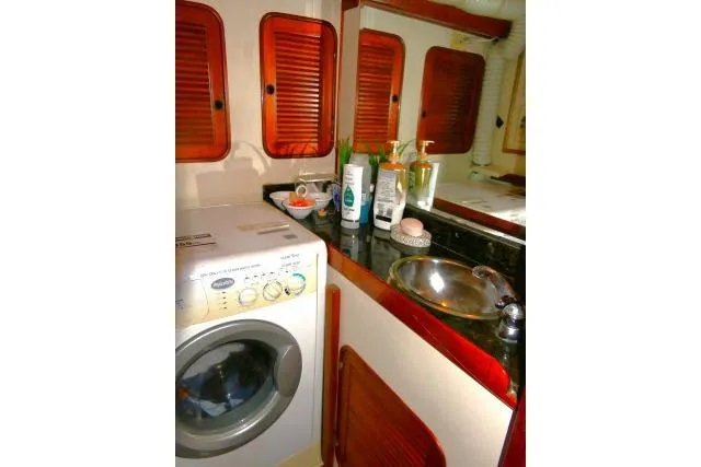 Slide: The Image of Brass clock and barometer on 1982 Ta Shing Mason 63 yacht interior. - 54