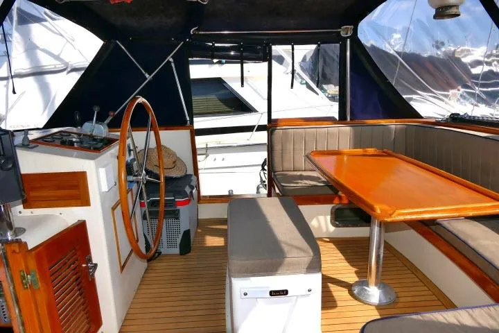 Slide: The Image of 1982 Ta Shing Mason 63 yacht cockpit with wooden accents and steering wheel. - 69