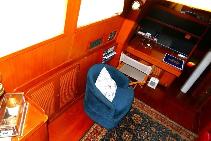 Slide: The Image of Cozy interior of 1982 Ta Shing Mason 63 yacht with seating and desk area. - 7