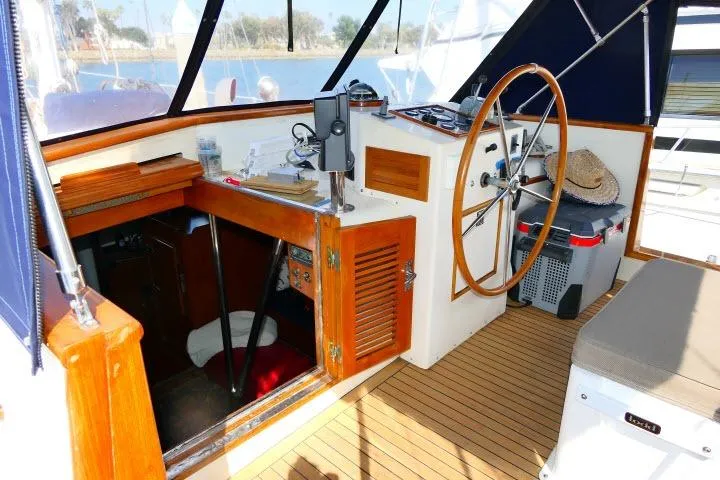 Slide: The Image of Helm of 1982 Ta Shing Mason 63 yacht with wooden wheel and navigation equipment. - 70