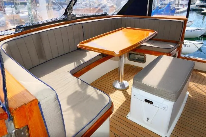 Slide: The Image of Interior of 1982 Ta Shing Mason 63 yacht with cushioned seating and wooden table. - 74