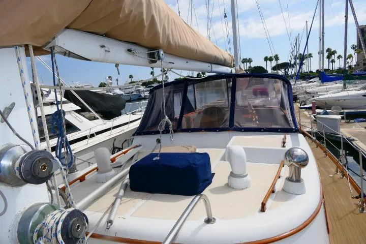 Slide: The Image of 1982 Ta Shing Mason 63 yacht with blue canopy and wooden deck details. - 76