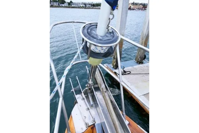 Slide: The Image of 1982 Ta Shing Mason 63 sailboat deck view at marina, showcasing teak wood finish. - 86