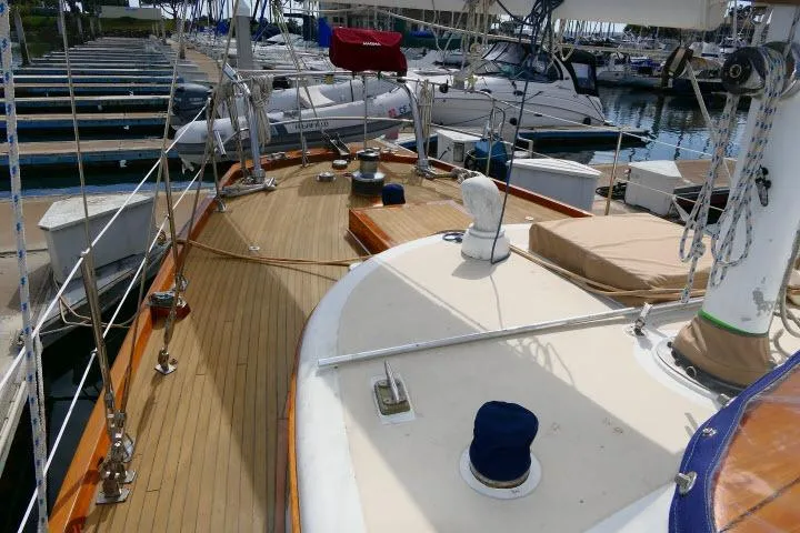 Slide: The Image of 1982 Ta Shing Mason 63 yacht docked with inflatable boat, clear sky background. - 88