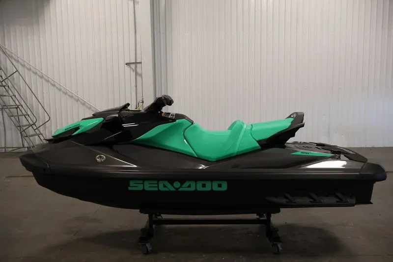 Slide: The Image of 2026 Sea-Doo GTI SE 130 jet ski with green and black design in a garage setting. - 16
