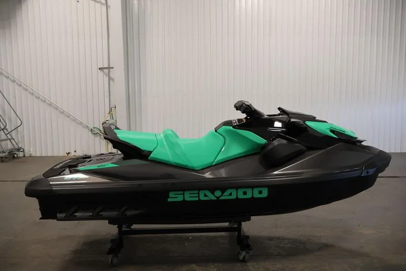 Slide: The Image of 2026 Sea-Doo GTI SE 130 jet ski in a garage, featuring a sleek black and green design. - 16