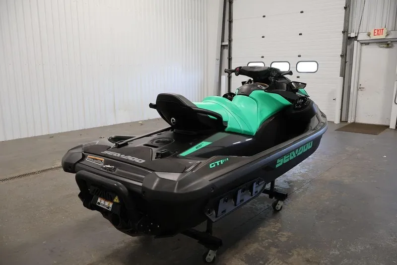 Slide: The Image of 2026 Sea-Doo GTI SE 130 jet ski in a garage, showcasing sleek design and vibrant colors. - 15