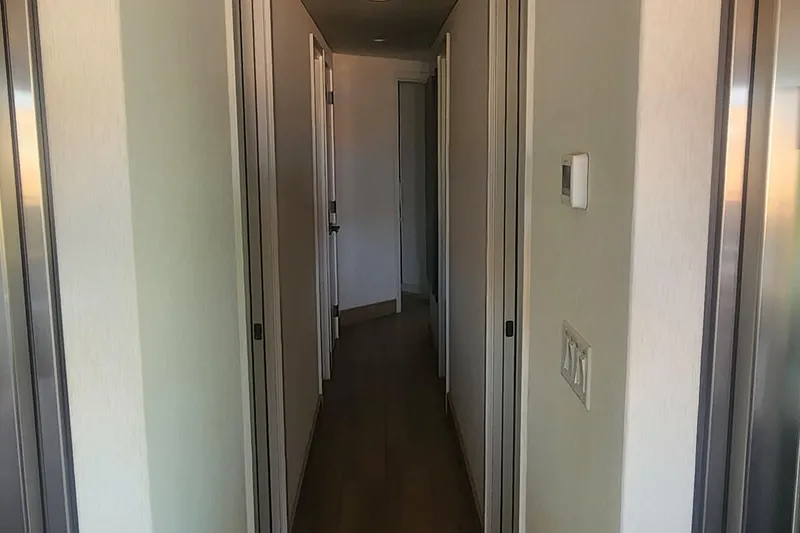 Slide: The Image of Narrow hallway with closed doors, modern design, Adonia Legacy Trip #15, 2022. - 12