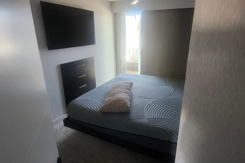 Slide: The Image of Modern bedroom with TV, dresser, and patterned bedding on Adonia Legacy Trip #15, 2022. - 18