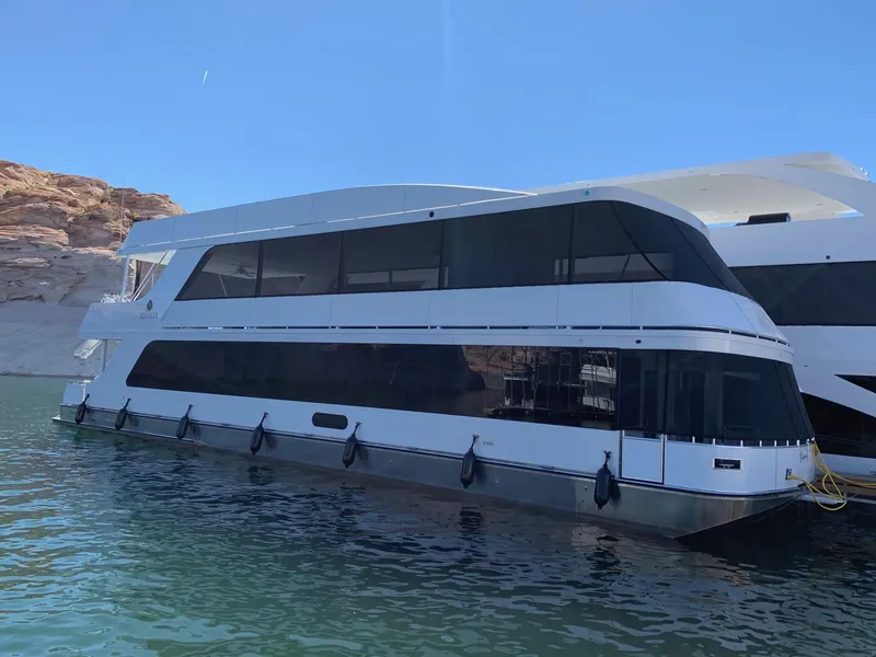 Slide: The Image of Luxury houseboat Adonia Legacy Share #11, 2022 model, docked on serene water. - 2
