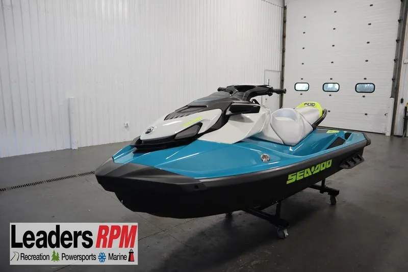 The Image of 2026 Sea-Doo GTI SE 130 jet ski in a showroom, featuring sleek blue and white design. - 1