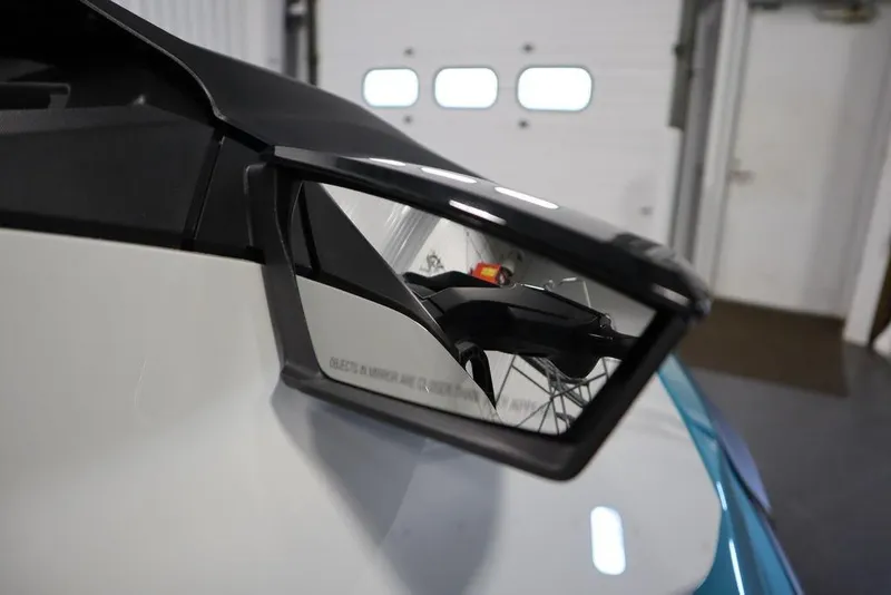 Slide: The Image of 2026 Sea-Doo GTI SE 130 side mirror reflecting interior garage view. - 14