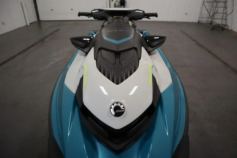 Slide: The Image of 2026 Sea-Doo GTI SE 130 jet ski in a garage, showcasing sleek design and vibrant colors. - 2