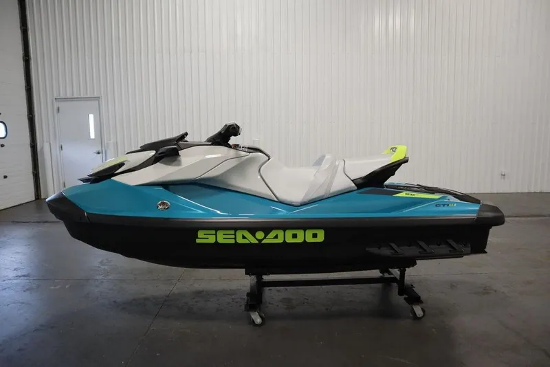 Slide: The Image of 2026 Sea-Doo GTI SE 130 jet ski in a showroom, featuring a sleek blue and white design. - 21