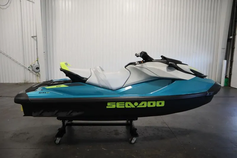 Slide: The Image of 2026 Sea-Doo GTI SE 130 jet ski in a showroom, featuring sleek design and vibrant colors. - 3