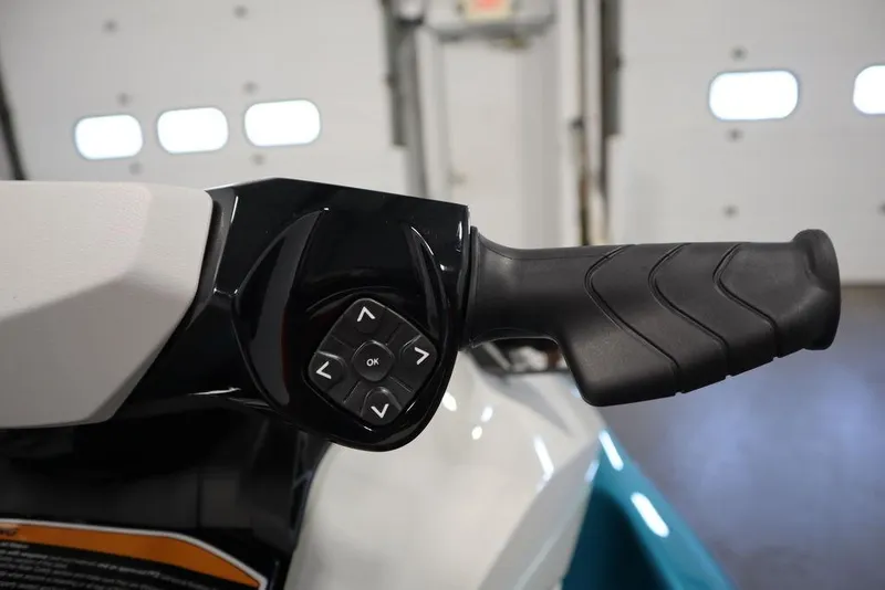Slide: The Image of 2026 Sea-Doo GTI SE 130 handlebar with control buttons in a garage setting. - 7